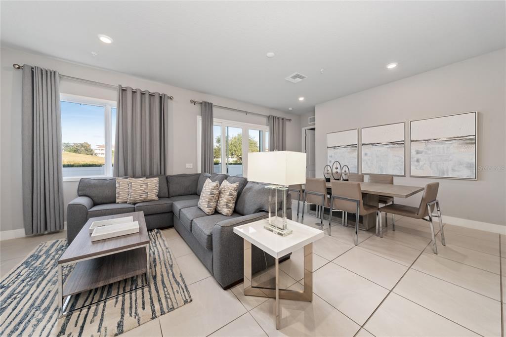 Aerial view of a residential complex featuring a central swimming pool and surrounding apartment buildings — 7740 SANDY RIDGE DRIVE UNIT 131, REUNION, FL