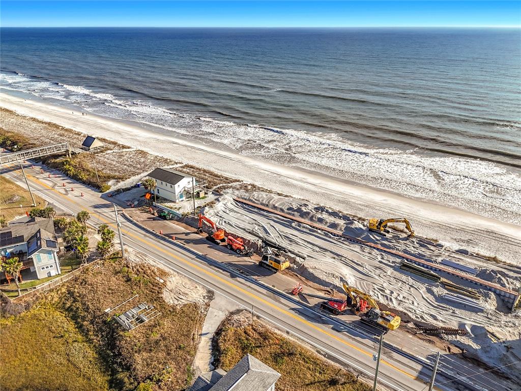 An aerial view shows construction equipment working on a beachside road near the ocean — 3560 COASTAL HIGHWAY, ST AUGUSTINE, FL