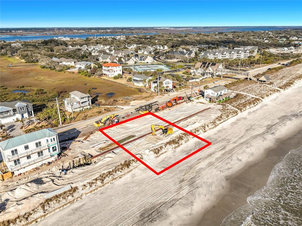 An aerial view shows a vacant beachfront lot with construction equipment and sand dunes — 3560 COASTAL HIGHWAY, ST AUGUSTINE, FL