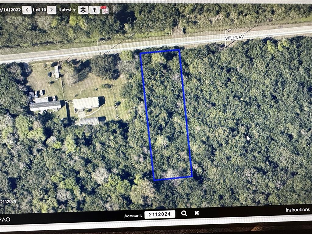 An aerial map view shows a rectangular plot of land outlined in blue near a road — WILEY AVE, MIMS, FL