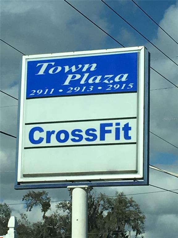 A rectangular sign for Town Plaza displays the address numbers and a CrossFit logo — 2915 NE JACKSONVILLE ROAD, OCALA, FL