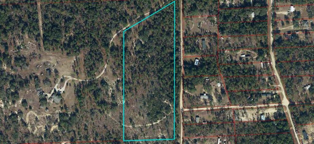 An aerial map shows a large, rectangular plot of land outlined in blue near a road — TBD NE 100 AVENUE, ARCHER, FL