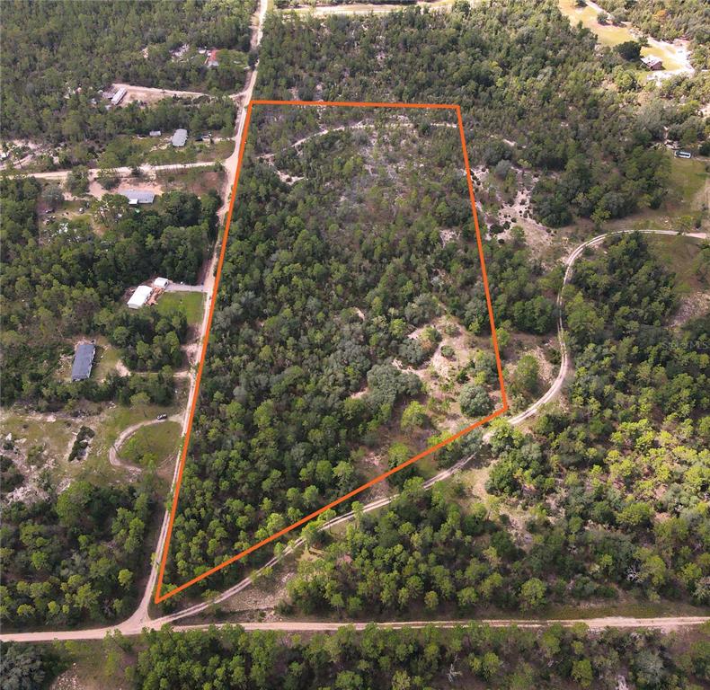 An aerial view shows a wooded, trapezoidal plot of land outlined in orange — TBD NE 100 AVENUE, ARCHER, FL