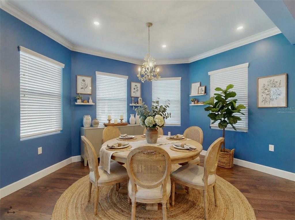 A kitchen with a central island, stainless steel appliances, and wood flooring — 76 DUERO STREET, ST AUGUSTINE, FL