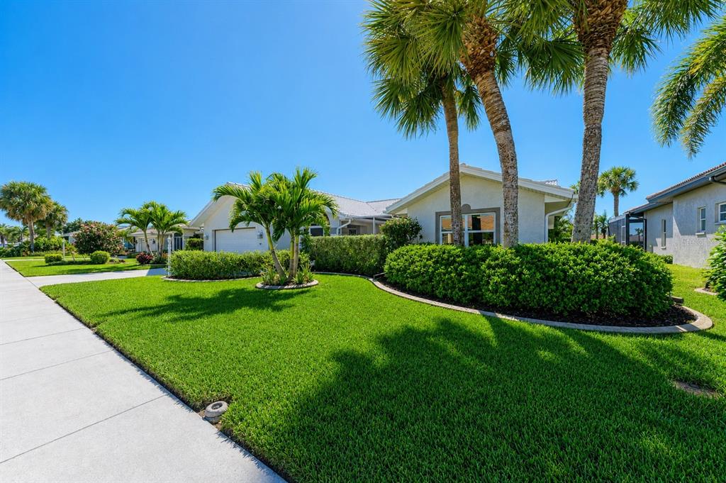 An aerial view of a suburban house with a pool cage overlooking a lake — 1679 VALLEY DRIVE, VENICE, FL