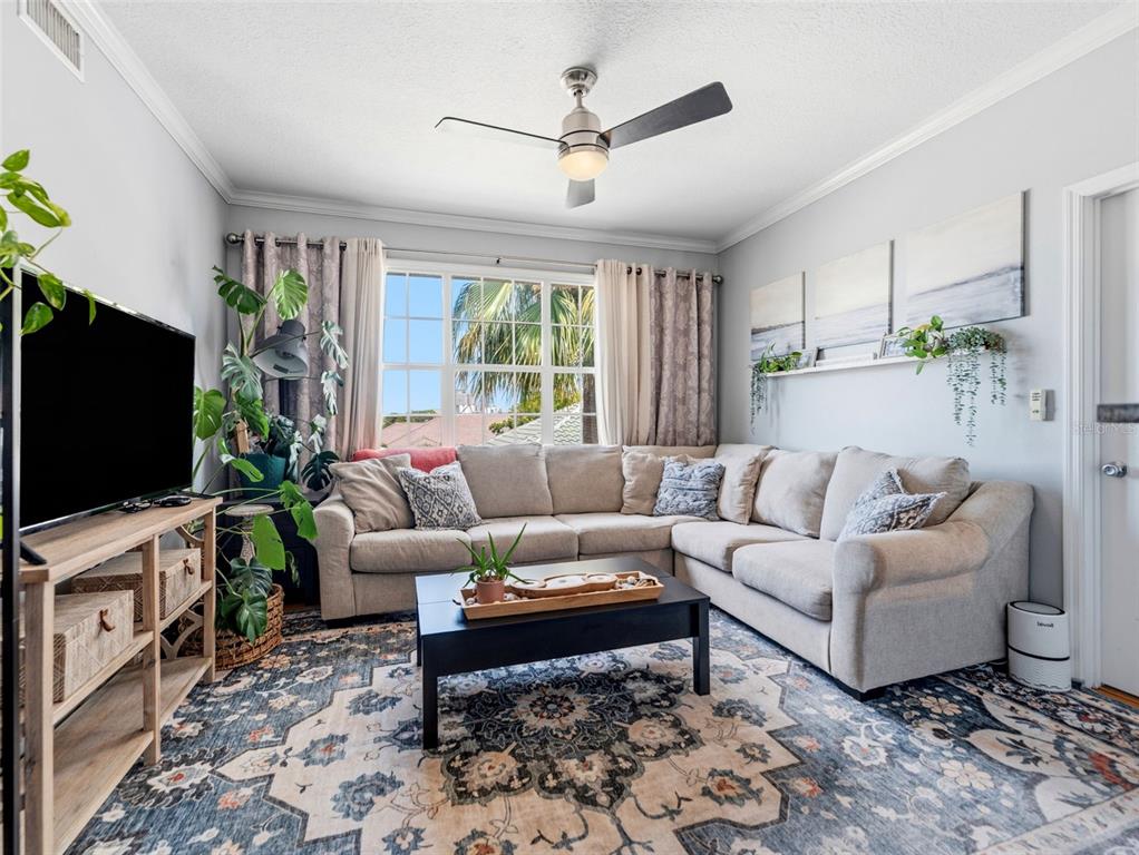 A dining area with wood floors, a dark table, and a view into the kitchen — 501 KNIGHTS RUN AVENUE UNIT 1325, TAMPA, FL