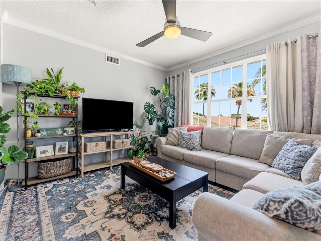 A dining area features a dark wood table, four chairs, and a console table — 501 KNIGHTS RUN AVENUE UNIT 1325, TAMPA, FL
