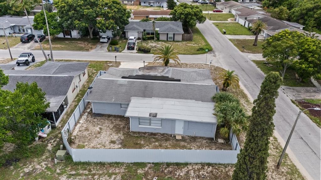 A single-story house with a concrete driveway, a palm tree, and a white garage door — 7511 TYSON DRIVE, PORT RICHEY, FL