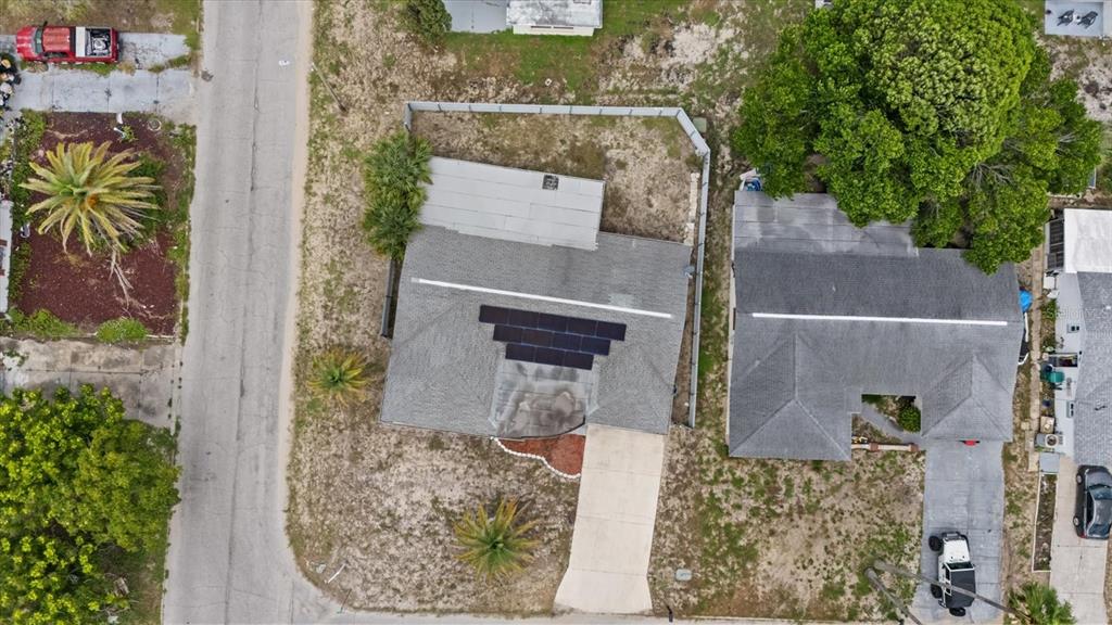 A single-story house with a light-colored exterior sits on a corner lot at sunset — 7511 TYSON DRIVE, PORT RICHEY, FL
