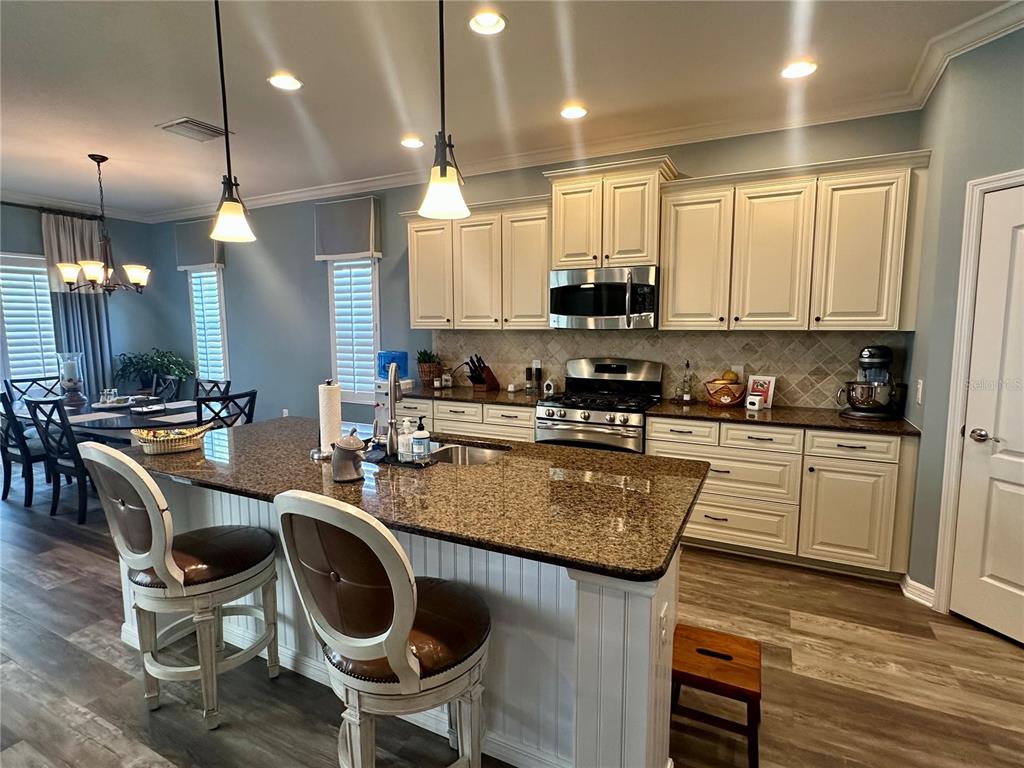 A single-story house with a two-car garage, a palm tree, and a landscaped front yard — 4811 SILVERMOSS DRIVE, SARASOTA, FL