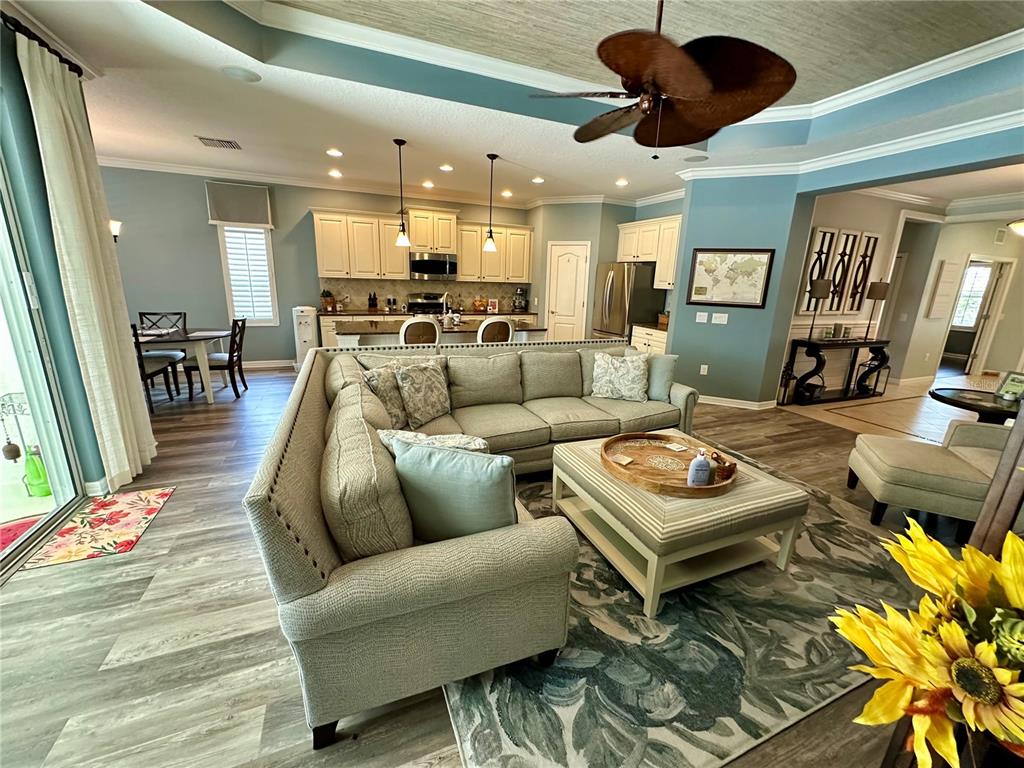 A concrete walkway leads to the front porch of a house with a palm tree — 4811 SILVERMOSS DRIVE, SARASOTA, FL