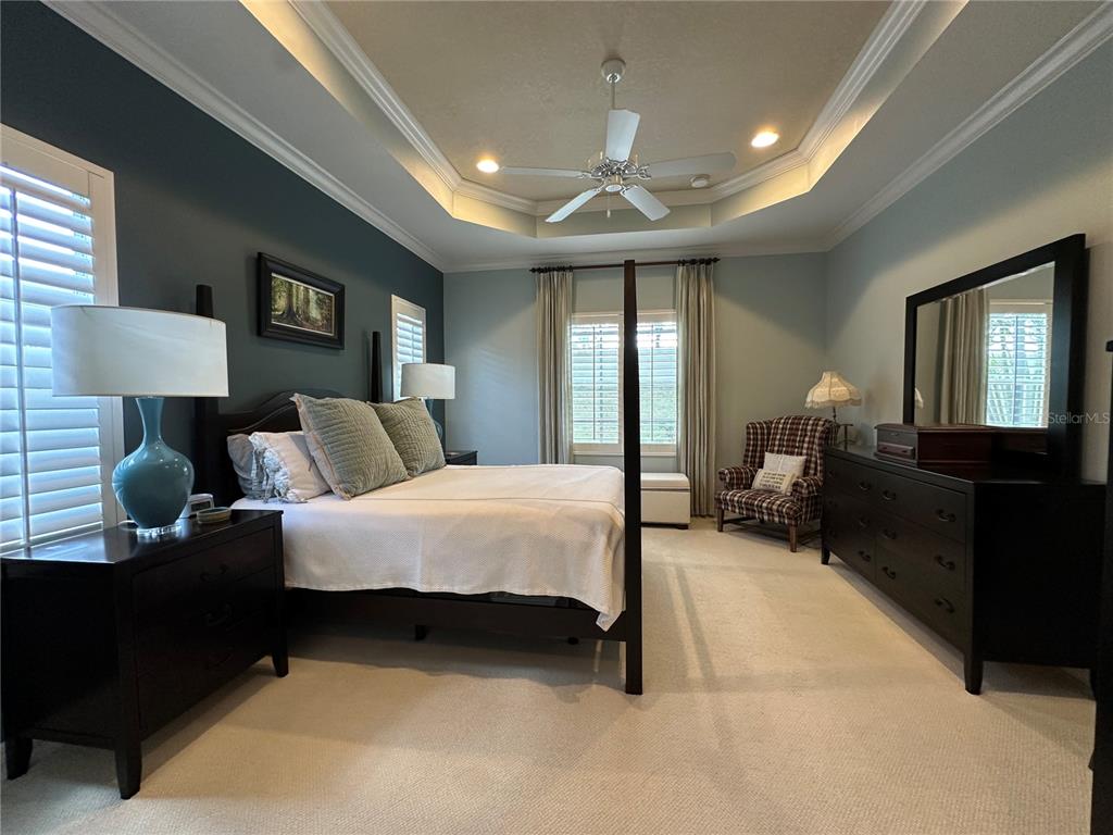 A concrete walkway leads to a covered entryway with a dark blue front door — 4811 SILVERMOSS DRIVE, SARASOTA, FL