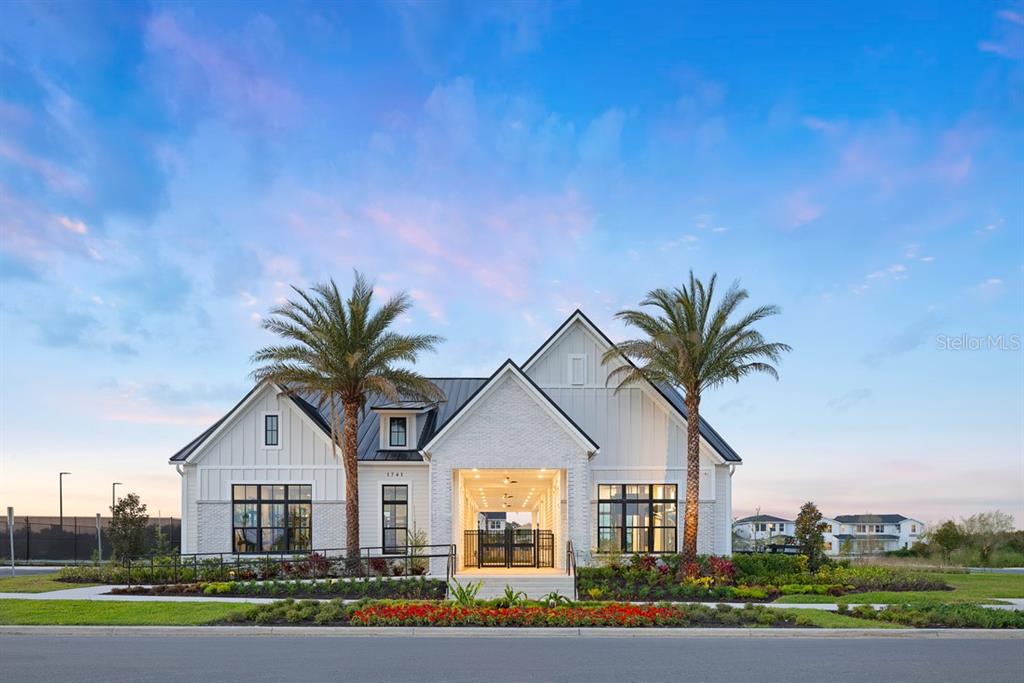 A modern white farmhouse-style building features a central covered entryway, two palm trees, and landscaping — 1585 STONECLIFF DRIVE, APOPKA, FL