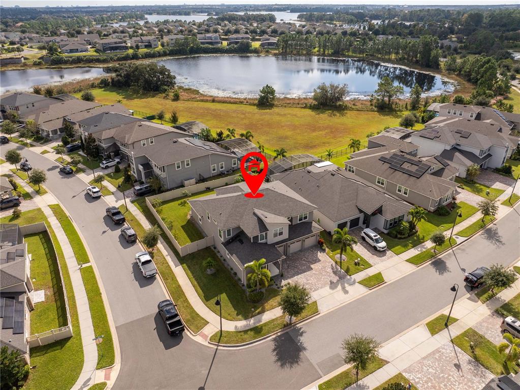 An aerial view shows a suburban house with a red location pin on its roof — 16894 WINGSPREAD LOOP, WINTER GARDEN, FL