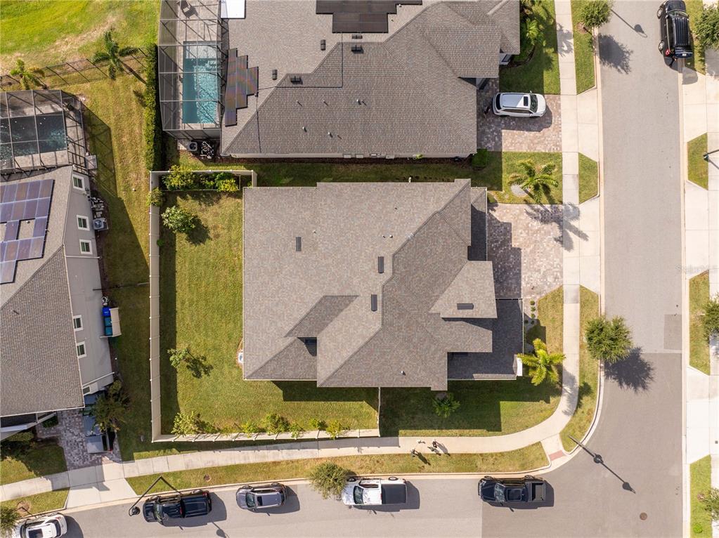 An aerial view shows a residential house with a shingled roof and a fenced yard — 16894 WINGSPREAD LOOP, WINTER GARDEN, FL