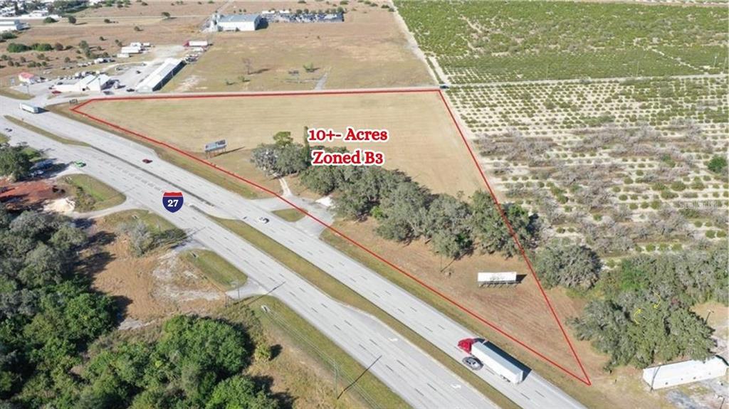 An aerial view shows a triangular plot of land adjacent to a highway — 4906 US HIGHWAY 27 S, SEBRING, FL