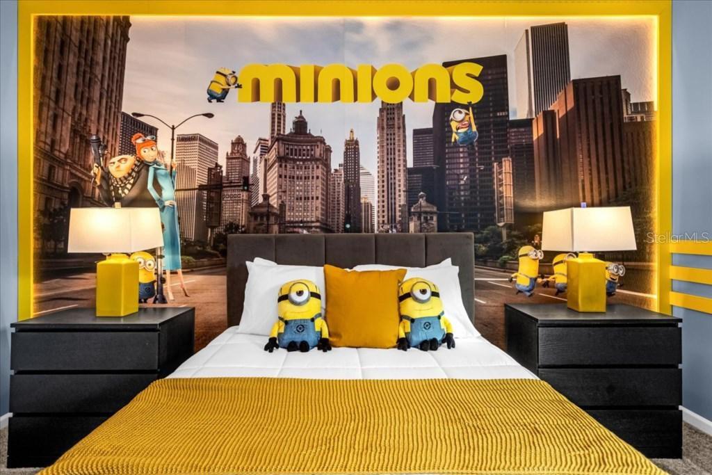 A bedroom features a Minions-themed wall mural, a bed with yellow bedding, and two nightstands — 8899 CABOT CLIFFS DRIVE UNIT 104, DAVENPORT, FL
