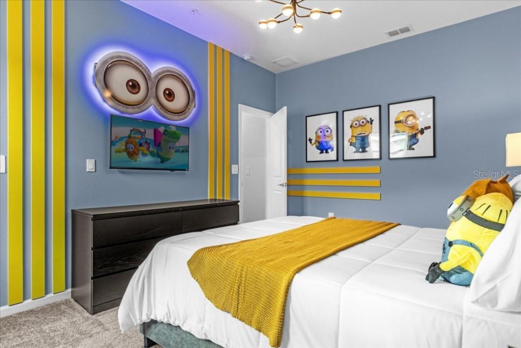 A bedroom features Minion-themed decor, including wall art, a character plush, and yellow accent stripes — 8899 CABOT CLIFFS DRIVE UNIT 104, DAVENPORT, FL