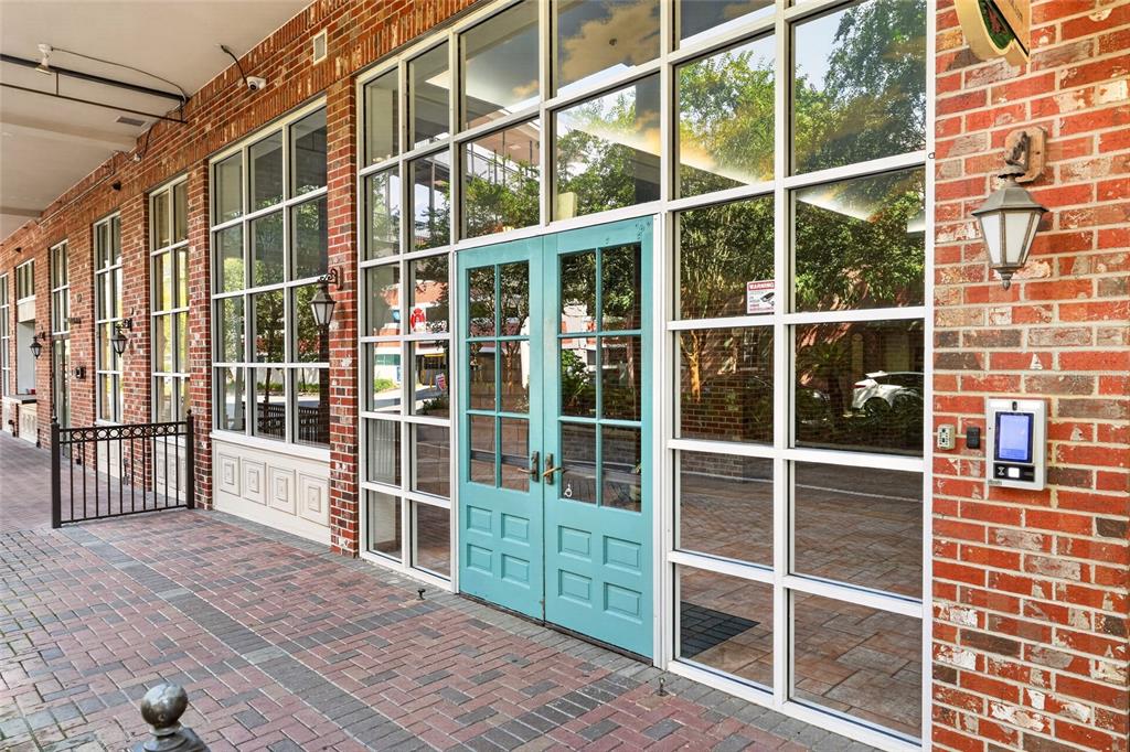 A brick building exterior features a teal double door entrance and a hanging station sign — 201 SE 2ND AVENUE UNIT 317, GAINESVILLE, FL