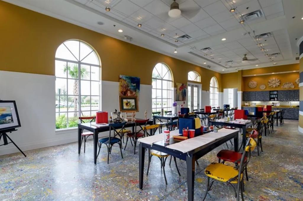 A beige single-story house with a paved driveway and a screened front porch — 122 FLAME VINE WAY, GROVELAND, FL