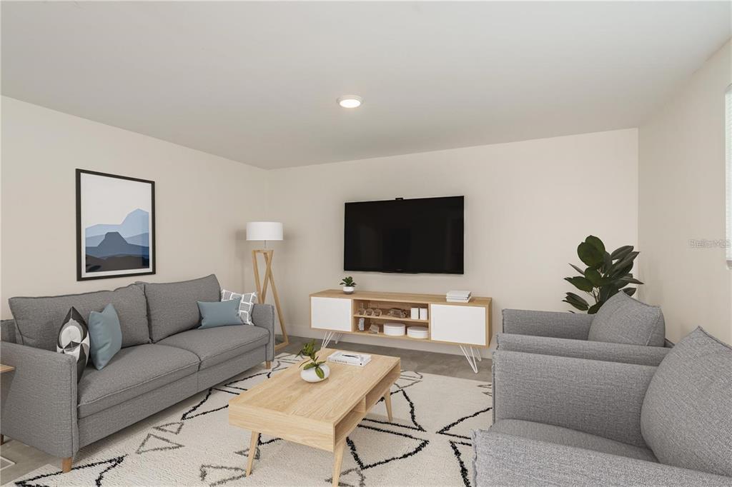 A living room features a gray sofa, two armchairs, a wooden coffee table, and television — 0 MARCHANT DRIVE, NEW PORT RICHEY, FL