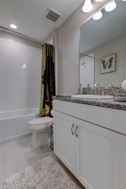 A bathroom features a white vanity with a granite countertop, a toilet, and a tub — 13118 JETER CREEK DRIVE, RIVERVIEW, FL