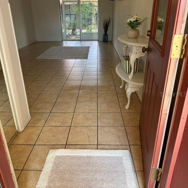 A kitchen features white cabinets, a white electric range, and a dark countertop — 3952 ELVIRA COURT, NEW PORT RICHEY, FL