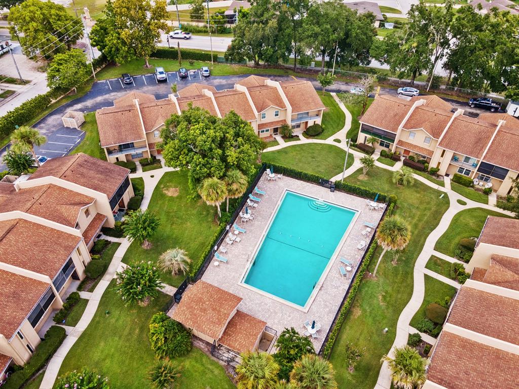 An aerial view shows a residential complex with a central swimming pool and surrounding buildings — 856 PARK LAKE CIRCLE UNIT 51, MAITLAND, FL