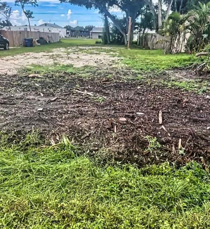 A vacant, partially cleared residential lot with grass, dirt, and scattered debris — 0 PARK ROAD, VENICE, FL