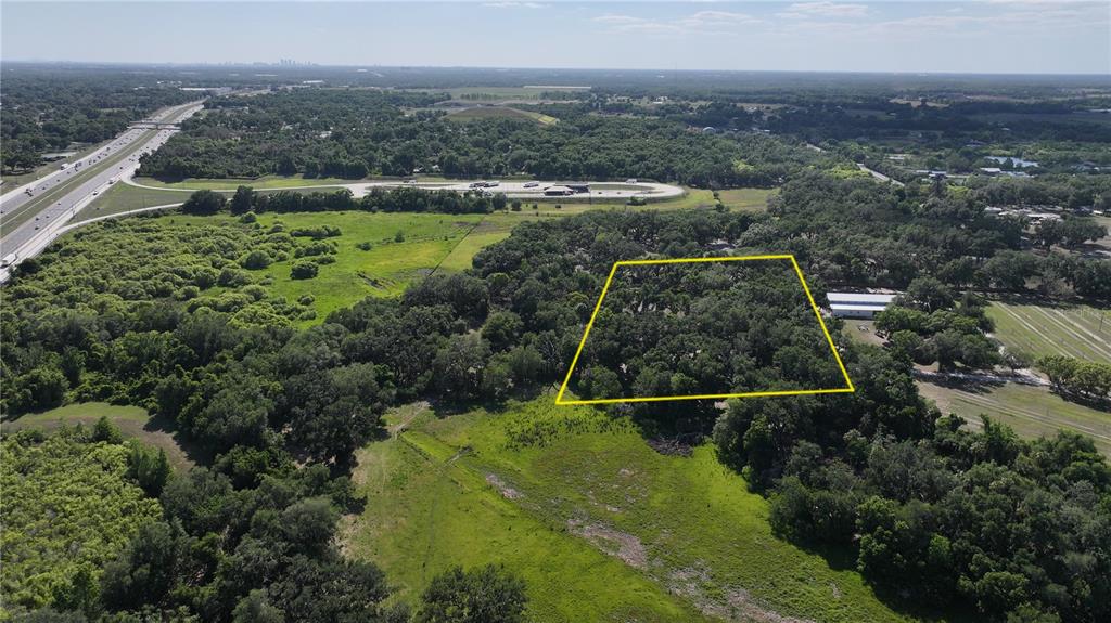 A wooded lot with large, moss-draped oak trees and patches of dirt and grass — MUCK POND ROAD, SEFFNER, FL