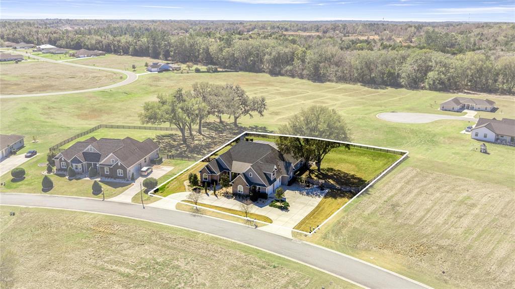 An aerial view shows a suburban house with a large yard and driveway — 1873 NW 85TH LOOP, OCALA, FL