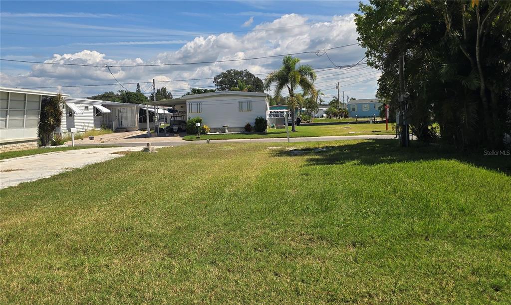 A white wall features the blue text Crystal Bay, a dolphin logo, and the number 2211 — 9 YAWL LANE UNIT 9, PALM HARBOR, FL