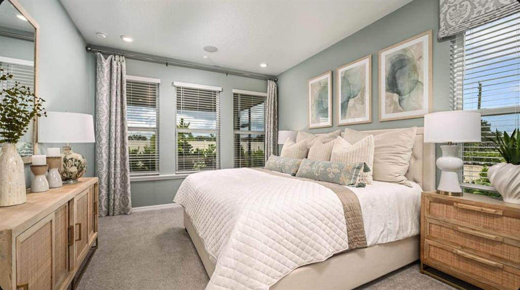 A living room with a vaulted ceiling, staircase, and an open kitchen in the background — 5770 BINNACLE LANE, COCOA, FL