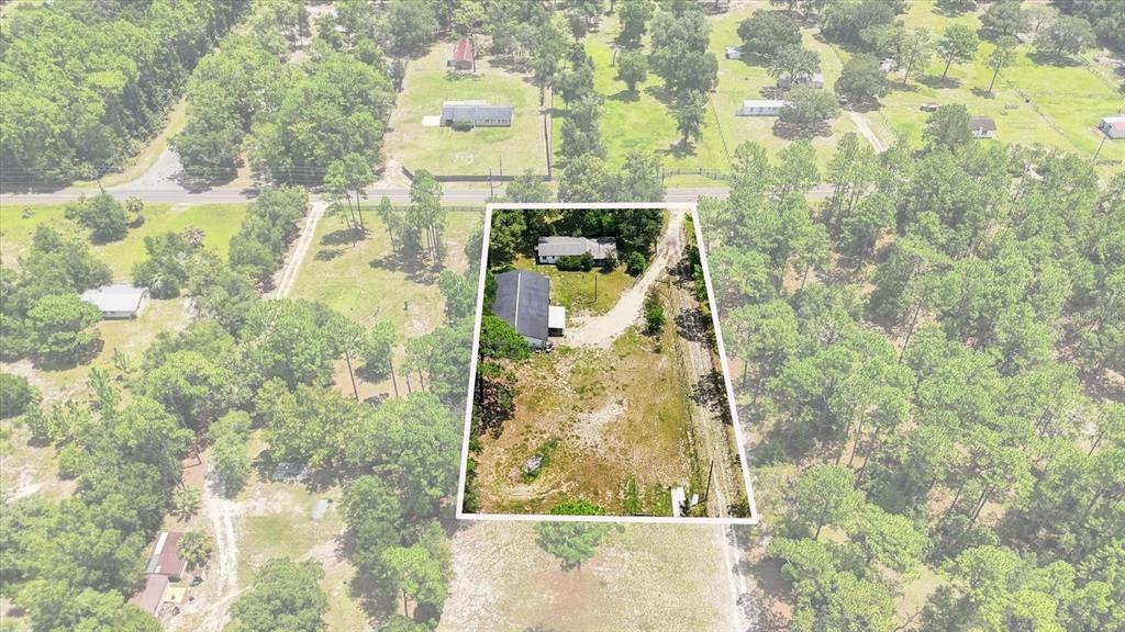 An aerial view shows a rural property with two buildings and a gravel driveway — 3750 SW 181ST COURT, DUNNELLON, FL