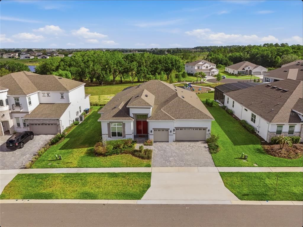 An aerial view of a house with a screened-in pool, spa, and patio — 16071 BARKLY RIDGE COURT, WINTER GARDEN, FL
