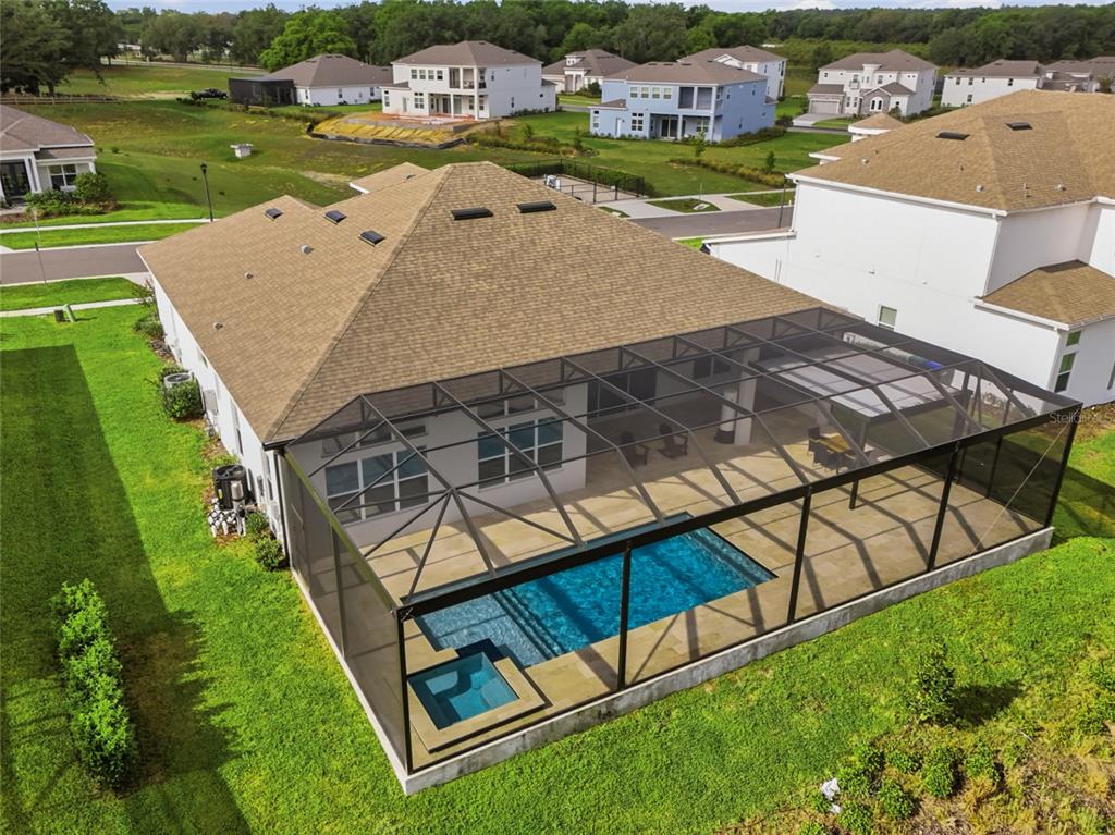 An aerial view shows a house with a shingled roof and a screened-in pool — 16071 BARKLY RIDGE COURT, WINTER GARDEN, FL