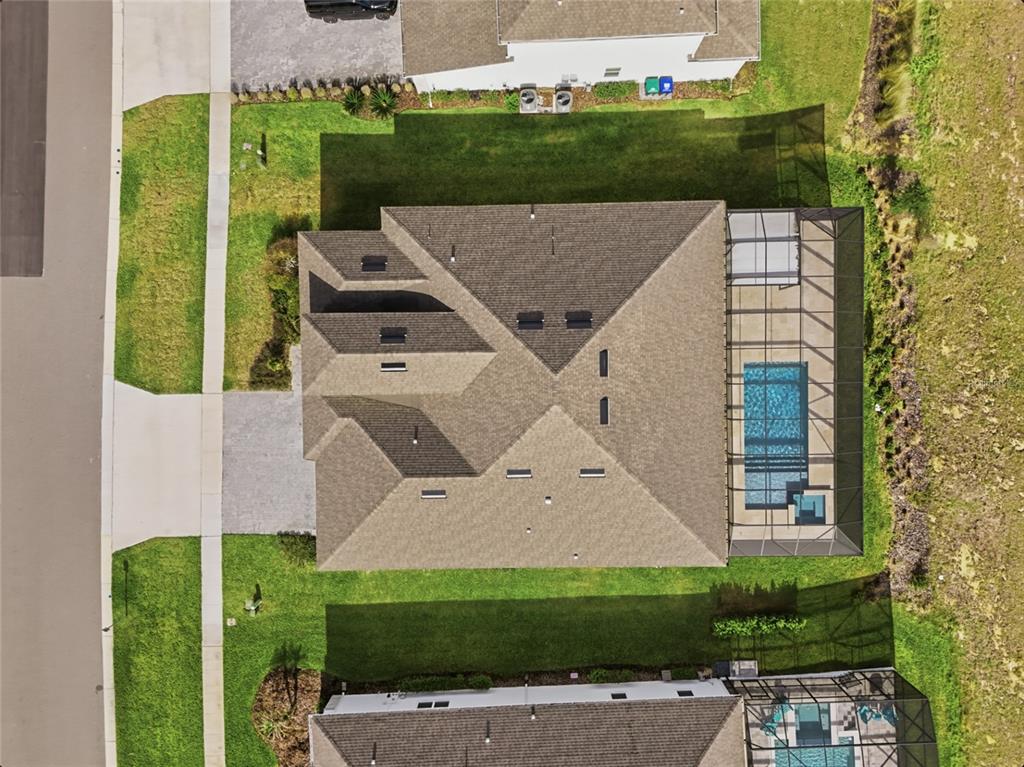 An aerial view shows a suburban neighborhood with houses, a playground, and a nearby lake — 16071 BARKLY RIDGE COURT, WINTER GARDEN, FL