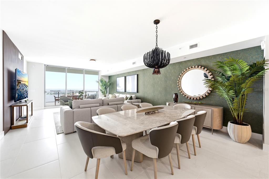 A modern dining and living area features a stone table, green accent wall, and balcony — 5713 BOWEN DANIEL DRIVE UNIT 1402, TAMPA, FL
