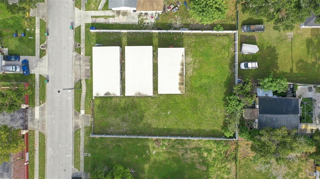 An aerial view shows a rectangular lot with three white structures and a fenced perimeter — 1417 30TH ST, ORLANDO, FL