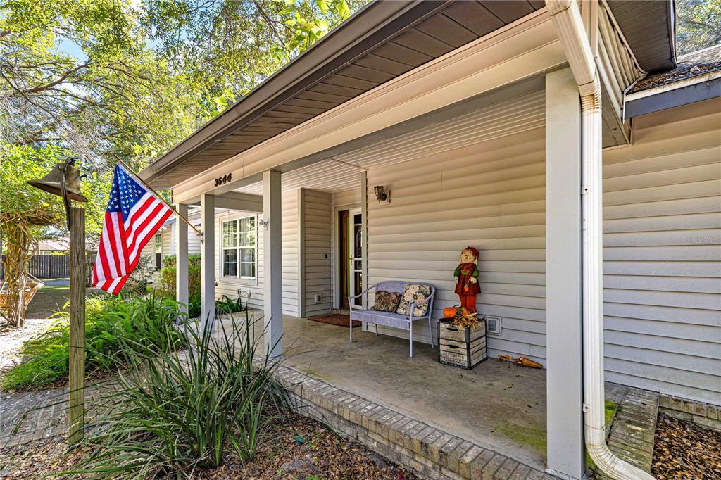 A view from an entryway looking into a living room with wood-look flooring — 3644 SE 22ND AVENUE, OCALA, FL