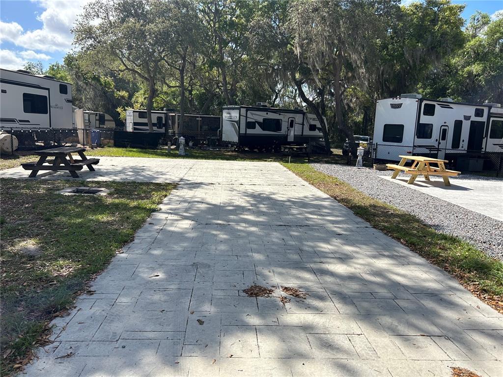 A large tree with Spanish moss stands in a grassy field behind a wooden fence — 15991 NE 243RD PLACE ROAD UNIT 54, FORT MC COY, FL