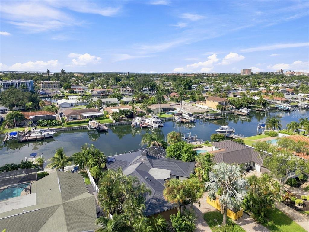 An aerial view shows waterfront homes with private boat docks along a canal — 3830 46TH AVENUE S, ST PETERSBURG, FL