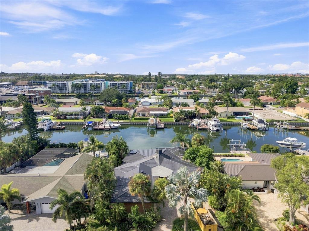 An aerial view of a waterfront residential neighborhood with boats docked along a canal — 3830 46TH AVENUE S, ST PETERSBURG, FL