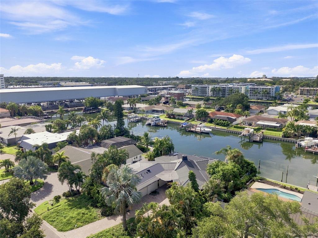 An aerial view shows waterfront homes with private docks along a canal near a marina — 3830 46TH AVENUE S, ST PETERSBURG, FL