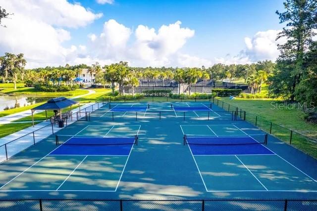 An aerial view of outdoor pickleball courts with a covered seating area nearby — 4563 SOUTHERN VALLEY LOOP, BROOKSVILLE, FL