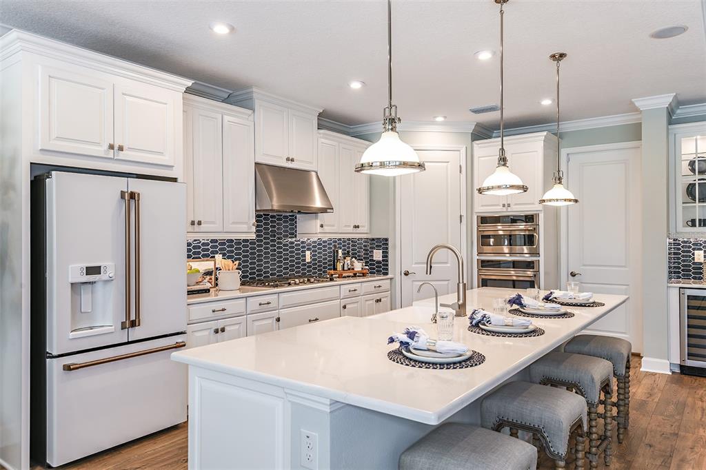 This is a floor plan for a single-story home featuring a primary suite and three garages — 16240 ALPHA GROVE PLACE, ODESSA, FL