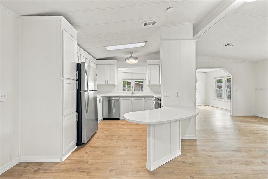 A covered porch features tiled flooring, a ceiling fan, and a door leading inside — 130 CLUBVIEW DRIVE UNIT 2, SAFETY HARBOR, FL