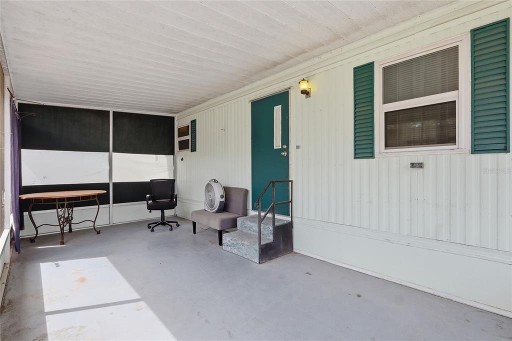 A kitchen features white appliances, wood-toned lower cabinets, white upper cabinets, and light-colored flooring — 37622 MARCH LANE, ZEPHYRHILLS, FL