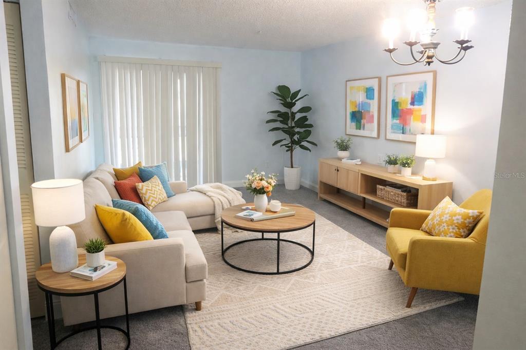 A living room features a beige sectional, a yellow armchair, and a round coffee table — 2864 N POWERS DRIVE UNIT 156, ORLANDO, FL