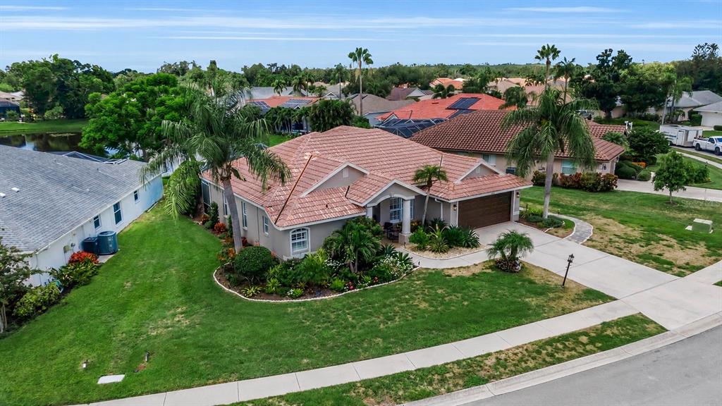 An aerial view of a single-story house with a tiled roof and a landscaped yard — 6817 CORRAL CIRCLE, SARASOTA, FL